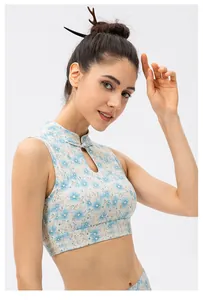 Detail of blue floral yoga vest featuring traditional frog button and teardrop cutout