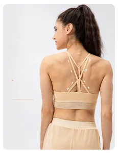 Detailed back view of beige yoga bra with cross straps and breathable mesh panel