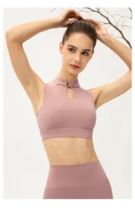 Detail of pink yoga vest with traditional Chinese frog button and teardrop cutout design