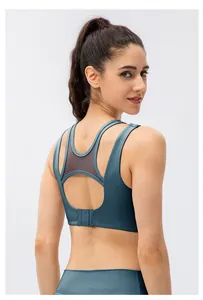 Detail view of misty blue sports bra with mesh splice and back multi-row buckle closure