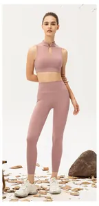 Pink yoga set featuring high neck cutout sports bra with traditional frog button details