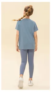 Close-up of breathable mesh fabric on kids quick-dry blue sports t-shirt and grey leggings