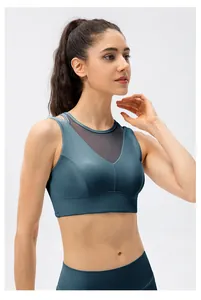 Close-up of dark teal sports bra featuring grey translucent mesh stitching on the neckline