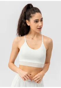 Detailed close-up of white yoga bra with thin straps and breathable mesh panel
