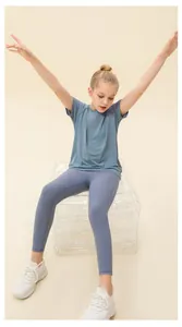 Detail of blue breathable kids sports set with quick-dry t-shirt and striped leggings