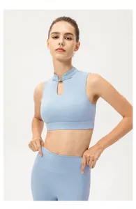 Detail of light blue yoga top featuring Mandarin collar and traditional frog button closure