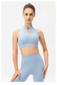 Detail of light blue yoga top with traditional Chinese knot and teardrop cutout