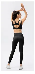 Detail of black sports bra with breathable mesh patchwork and hollow racerback design