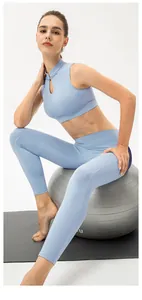 Detail of light blue yoga set with mandarin collar and hollow-out design on a yoga ball