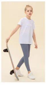 Full-body view of girl in white breathable mesh T-shirt and grey-blue athletic leggings