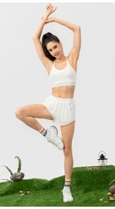 Detailed full body shot of white sports bra and high-waisted shorts set on model