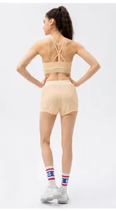 Detail view of the light beige yoga bra featuring an elegant criss-cross back strap design