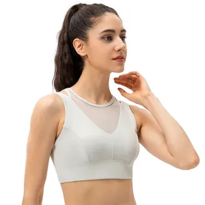 Beige yoga sports bra with mesh paneling and double shoulder straps for women
