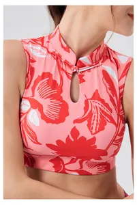 Detail of pink floral yoga vest featuring traditional Chinese frog button and teardrop cutout