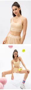 Detail of a beige medium-impact yoga bra and loose shorts set for fitness activities