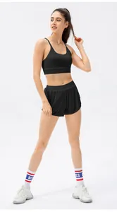 Detail view of black yoga two-piece set with thin strap sports bra and wide-leg shorts