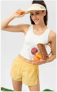 Detail of white slim-fit racerback sports vest and yellow elastic waist gym shorts