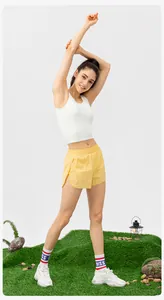 Detailed full-body view of white sports tank top and yellow shorts for yoga and running