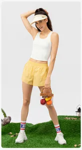 White high-impact sports bra and yellow shorts paired with stylish outdoor fitness gear