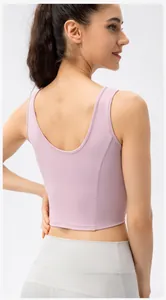 Detail view of the U-shaped back and seamless fabric of the pink sports bra
