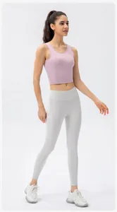 Detail of high-waist yoga leggings with side pockets and racerback sports bra for women