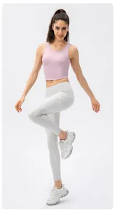 Detail view of pink high-impact sports bra and white yoga leggings with side pockets