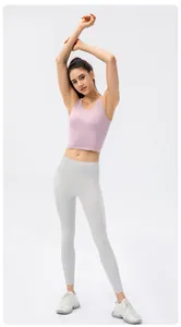Detailed shot of lavender yoga tank top and grey high waist leggings on a female model