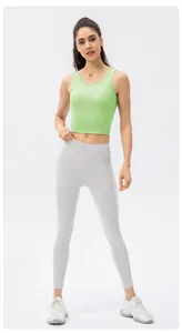 Close-up of avocado green sports vest and grey high-waist leggings on a model