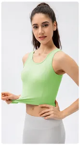 Detailed close-up of light green high-impact sports bra showing elastic fabric and slim fit