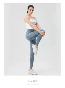 Detail of high waisted blue marble tie-dye yoga pants with a white tank top for women