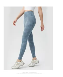 Side view of high-waisted blue tie-dye yoga leggings with flattering tummy control fit