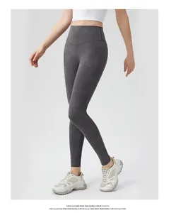 Macro detail of high-waist yoga leggings showing dark gray moisture-wicking fabric