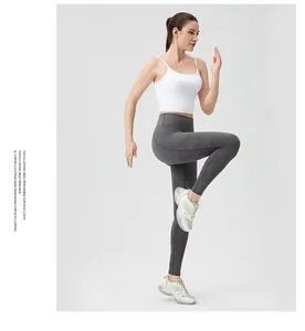 Detail view of high-waist yoga leggings with ergonomic stitching and white sports top