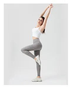 Detail of high-waist marble print yoga leggings and white sports vest on model