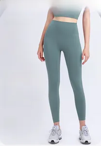 Detail view of high-waist green yoga leggings showing seamless fit and high-stretch fabric