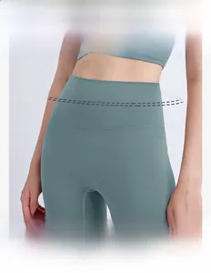 Detail of high waisted yoga leggings showing the wide elastic waistband in grey green