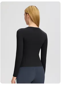 Haut de yoga noir à manches longues moulant montrant la coupe du dos et le tissu extensible