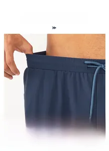 Detail of navy blue sports shorts with elastic waistband and internal drawstring cord