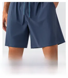 Detail of loose leg opening and breathable quick-dry fabric on men's navy sports shorts