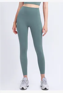 Detail of high-waist yoga leggings and sports bra set in premium green-gray stretch fabric