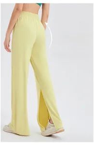 Detail view of high-waisted wide-leg yoga pants with side slits and elastic pleated waistband