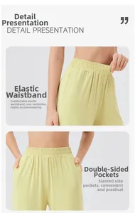 Detail of high-elastic waistband and side pockets on light green sports trousers