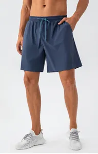 Close-up of men's quick-dry navy blue sports shorts with an elastic drawstring waistband