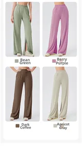 Detail of high waist yoga pants showing side slits in bean green and berry purple