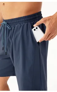 Detail showing invisible side pocket of quick-dry shorts holding a smartphone
