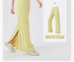 Detail view of high-waist loose yoga pants with side slits and silky drape texture