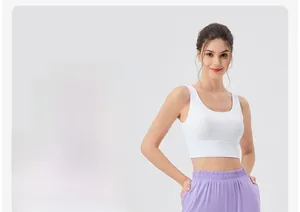 Detail of high-waisted lavender yoga pants with elastic waistband on model