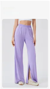 Macro detail of high-waist lavender yoga pants featuring elastic waistband and front slit hem