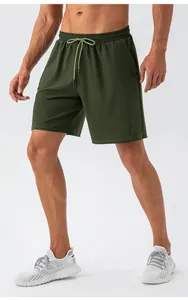 Detail of olive green athletic shorts with elastic drawstring waist and side pockets