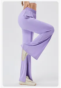 Detail view of high waisted purple yoga pants with side slits and flowy drape fabric